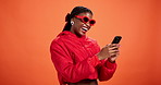 Laughing, phone and sunglasses with black woman on wall background for reaction to social media post. Fashion, funny  and shades with happy African person in orange studio for mobile communication