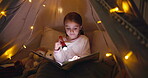 Reading, book and child with torch, tent or learning with novel on bed, hobby and knowledge in home. Night, growth and development of girl with story, literature or kid with tech for fiction in house
