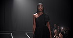 Woman, model and runway with dress for fashion show, garment collection or designer brand. Female person, crowd or audience with clothing line for style, publicity or fashionable trend on walkway
