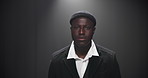 Fashion, walking and black man on runway with designer brand, clothes and outfit at showcase event. Aesthetic, catwalk and model on a stage for couture collection, trendy style and luxury wardrobe