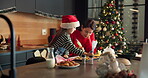 Child, mom and piping cooking for Christmas decoration, icing skills and sweet treats in kitchen. Kid, woman and helping with baking, festive preparation and Santa snacks by bonding together at house