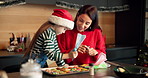 Mom, kid or piping cookies with christmas treats, decorations or santa snacks in kitchen at home. Mother, child or daughter baking with help for festive preparation or meal prep on december holiday