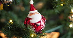 Christmas, tree and santa bauble in home for holiday decoration, festive season and celebration. Claus, xmas and ornament closeup for December tradition, vacation and party event in house with bokeh