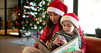 Christmas, mom and reading book in home, storytelling and bonding with story for daughter or lounge. House, growth and development of child with fiction, woman and literature for girl in living room