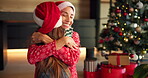 Christmas, child and hug mother in home for holiday celebration, festive season and tradition. Happy family, people and embrace with santa hat for presents, gratitude and bonding together with love