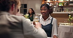 Couple, cheers and drinking wine at restaurant on date, talking or smile for romance. Toast, interracial man and woman with alcohol glass to celebrate relationship, anniversary or love at dinner