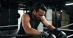 Fitness, boxing ring and tired man on rope for break, relax or exhausted with challenge. Athlete, boxer and rest in gym for breathing, fatigue or workout recovery with intense pain for fight or sport