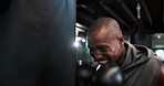Boxing, power and punching bag with black man in gym for combat sports, fight or workout. Exercise, fitness and force with athletic boxer in health club for conditioning, skill or strength training