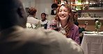 Couple, toast and drinking wine at restaurant on date, talking or smile for romance. Cheers, interracial man and woman with alcohol glass to celebrate relationship, anniversary or commitment for love
