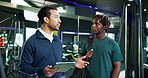 Consulting, man and personal trainer with tablet in gym for planning of training program. Advice, conversation or exercise with client and fitness coach in club for development of workout schedule