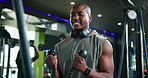 Active, black man and machine for fitness in gym for bicep exercise, training and bodybuilding. Male person, pulldown equipment for strong muscles, power workout and performance for body development