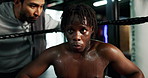 Man, boxer and rest with coach in boxing ring for motivation, coaching advice and tips of tournament. Male person, instructor and physical assessment of fight, competition plan and recovery for match