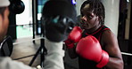 Man, boxer and training in ring with coach for self defense, fighting or martial arts at gym. Male people, fighter or boxing with sparring partner or instructor for sport, practice or technique