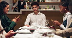 Lonely, man and friends with smartphone, restaurant or group with tech for texting or communication. Depressed, customer and people with mobile, typing and sad on break in diner, online and thinking