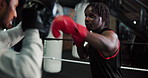 Man, boxing and training in ring with gloves for self defense, fighting or martial arts at gym. Male people, fighter or boxer with sparring partner or coach for sport practice, punching or technique