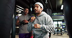Boxing, training and personal trainer with athletes in gym with learning to punch with technique for fitness. Workout, challenge and coach with boxers for power punching with exercise in sport center