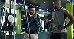 Men, fitness coach or weightlifting with demonstration on cable pulley machine for arm exercise. Male people, instructor and helping customer with training technique for workout tips or health at gym