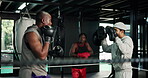 Training, boxer and man with coach, fight or practice with gloves for self defense, wellness or gym. Boxing, fitness and athlete with personal trainer for sport, people or preparation for competition
