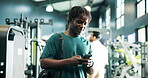 Athlete, man and happy with phone at gym for training progress, chat notification and exercise app. Fitness, person and sports bag with smartphone at health club for workout tracking and performance