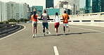 Back, fitness and group running in city for body health, wellness and training. Road, people and friends with cardio workout on bridge together for marathon, endurance and runners race for sports