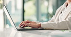 Hands, laptop and typing with business person at desk in office for report or research. Administration, computer and keyboard with professional accountant in workplace for financial management