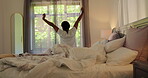Wake up, back and woman with stretching on bed for morning routine, start day and muscle relief. Awake, person and hands raised in bedroom for comfortable sleep, energy and feeling fresh from rest