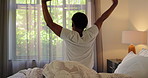 Wake up, stretching and back of woman in bedroom for morning routine, ready and start day. Awake, home and person for wellness, health and peaceful after resting, relaxing and comfortable sleep