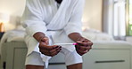 Hands, anxiety or woman with pregnancy test on bed for fertility news, stress or waiting on results. Nervous, person and impatient with stick in home for ivf, ovulation planning and infertility risk