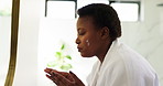 Bathroom, cream and black woman with skincare, smile and confidence with healthy skin. African person, home and cosmetics with creme, dermatology and wellness with shine, face treatment and beauty