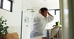 Hair care, bathroom and black woman in home in morning with getting ready for day with health. Wellness, cosmetic and African female person with afro hairstyle for growth routine in apartment.