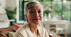 Happy, relax and face of senior woman on sofa in home with calm on weekend morning in living room. Smile, couch and portrait of elderly female person from Colombia in retirement in lounge at house.