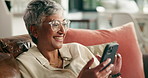 Laugh, sofa and mature woman with phone for social media, communication and contact in home. Retirement, house and person relax on smartphone for reading online article, news and funny message