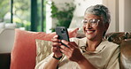 Old woman, laughing and typing with phone on sofa for funny text, social media meme or online news. Retirement, person and happy with smartphone in home for streaming service and reading comedy ebook