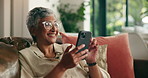 Relax, sofa and mature woman with phone for social media, communication and contact in home. Retirement, happy and person laugh on smartphone for reading online article, news and funny message