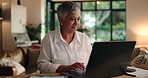 Remote work from home, internet and woman with laptop, typing and trading with connection. Mature person, employee and computer with website info, stock market and financial system with email and app