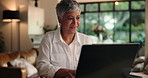 Laptop, tablet and mature woman in home office for editing draft, ebook and remote work. Computer, happy freelancer and typing email for review, writing story and author reading publication approval