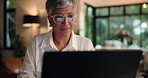 Night, employee and woman with glasses for laptop, work from home or review of financial performance. House, accountant and mature person with eyewear for tech, reading or analysis of business growth