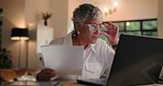 Documents, glasses and laptop with senior woman in home at night for budget, finance or investment. Computer, paperwork and reading with mature person in apartment for financial planning or review