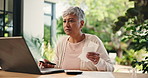 Senior woman, laptop and receipt at house of budget stress, financial crisis and payment mistake. Elderly person, frustrated or online with document of mortgage bills, expenses invoice and bankruptcy