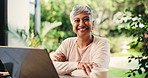 Mature woman, patio and remote work with face, laptop and freelance online news editor in home. Happy, smile and newsletter update with arms crossed, entrepreneur and confidence for website research