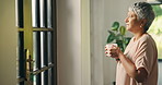 Coffee, thinking and senior woman in house with vision for peace, calm and walk to door for view. Living room, tea cup and person with reflection, mindset and thoughts for daydreaming in retirement