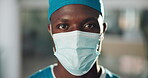 Black man, face mask and surgeon at hospital for medical personnel and healthcare compliance. PPE, protection and male person for surgery with confidence, portrait and safety regulations for policy