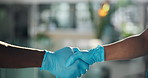 Healthcare, doctors or gloves with handshake in hospital for surgery, collaboration or introduction. Health experts, people and shaking hands in clinic for operation success and medical cooperation