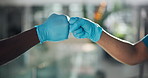 Handshake, fist bump and healthcare team with gloves for protection, safety and support for surgery. Health, special hand gesture and people in unity in medicine, partner and hygiene for medical care
