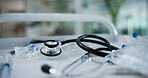 Cardiology, healthcare and urgency with stethoscope in hospital for insurance or wellness closeup. Emergency, instrument and treatment with medical equipment on moving cart for examination in clinic