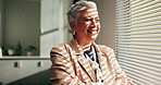 Thinking, mature and business woman by window for financial planning, problem solving or confidence. Office, thoughts and happy manager with vision, insight or arms crossed for investment by blinds
