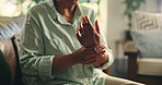 Home, sofa and hands with wrist pain for arthritis, muscle tension and carpal tunnel in retirement. House, couch and senior person with joint ache for fibromyalgia, osteoporosis and inflammation