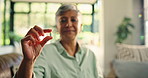 Home, treatment and hands with pills, healthcare or swallowing medicine with water or elderly woman. House, wellness and senior person with antibiotics for health condition, retirement and illness