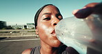 Fitness, hydration or black woman with drinking water in city for running break, thirsty or recovery. POV, runner face and liquid in road for workout refresh, marathon exercise or training challenge