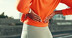 Hands, athlete and woman with back pain outdoor for sports injury, fitness mistake and muscle sprain. Active, female person and sore spine with inflammation, joint problem and accident from exercise